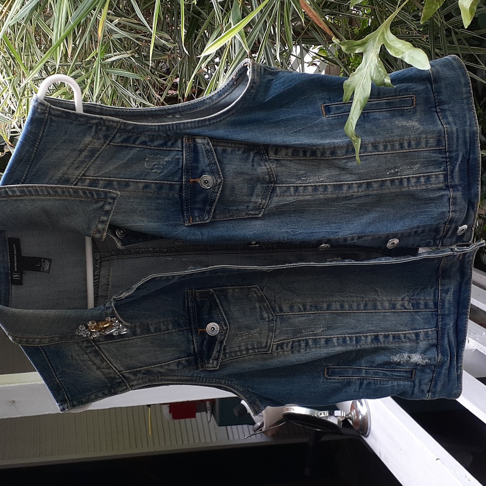 Denim vest.  Distressed  with  jewels